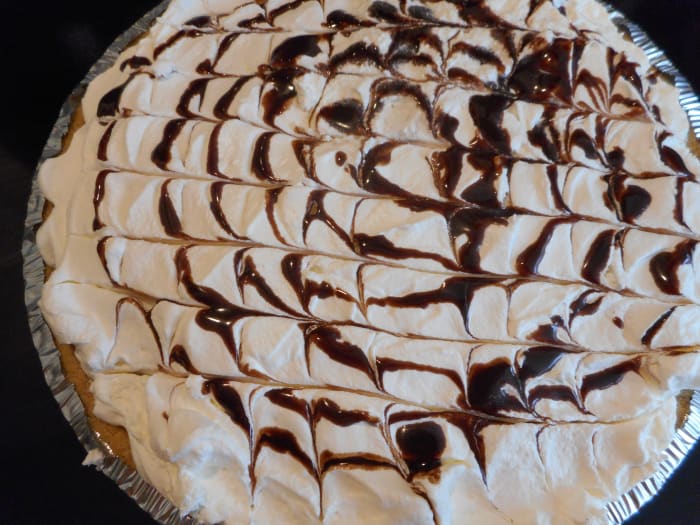 Drizzle with chocolate syrup and run a toothpick from one side to the other side for a pretty effect. For my pie, I started drizzling syrup in the center of the pie and swirled it until I reached the outer edge.
