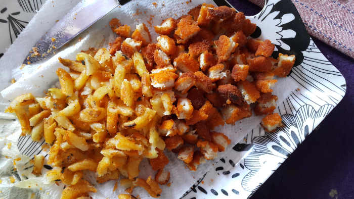 Once fried, break the chicken nuggets and curly fries into small pieces as shown in the picture.