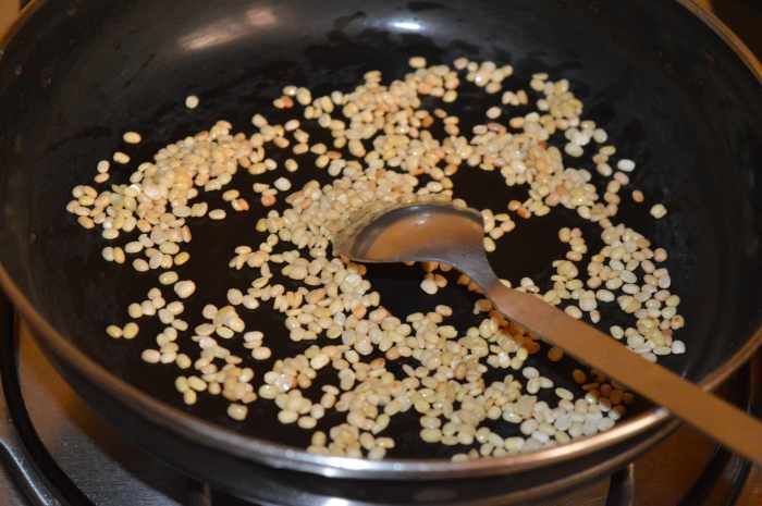 Step one: Roast split white lentils over medium-low heat with a few drops of oil. Saute them until they are golden brown. A nice aroma will arise from the roasting lentils.