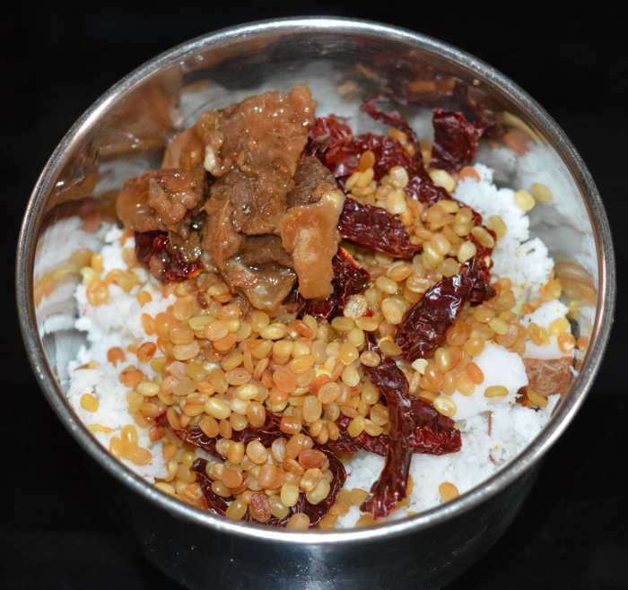 Step four: Add grated coconut and salt. Grind, adding enough water to get a near-smooth paste. Transfer it to a bowl.
