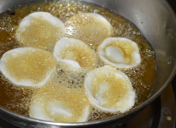 Step seven: Deep-fry 6 to 7 of them at a time over medium heat. Turn them occasionally to ensure uniform frying.