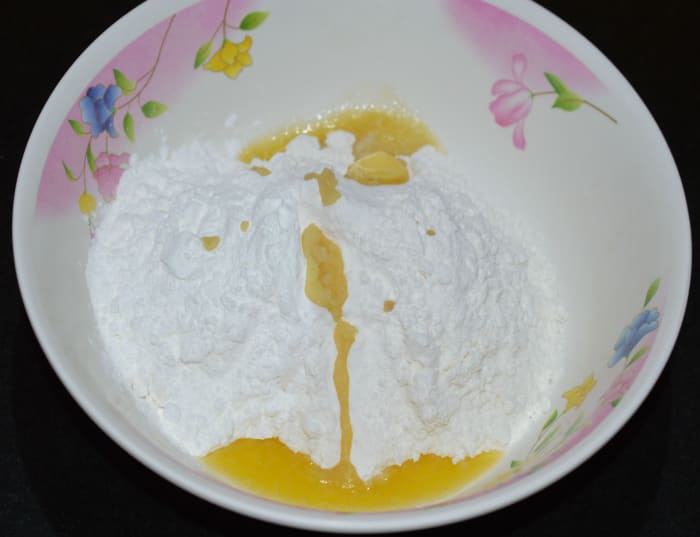 Step one: Put all-purpose flour, corn flour, liquid butter, and salt in a mixing bowl. Dry-mix them. Add water little by little and knead to get a smooth and firm dough.