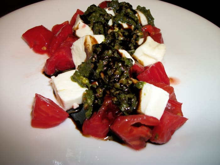 Traditional Caprese Salad is made by alternating slices of tomato and mozzarella. I have cut mine in cubes.