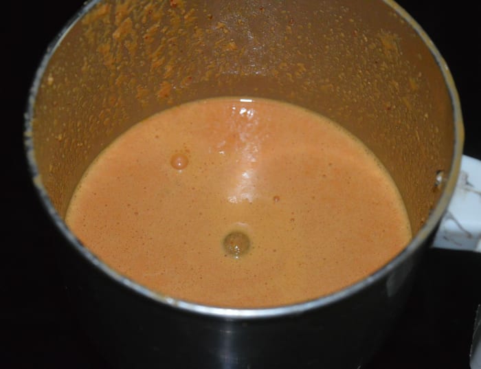 Step two: Put grated coconut, mustard seeds, and dry red chilies in a mixer or blender. Grind, adding some water, to get a smooth sauce. Transfer it to the mixing bowl.