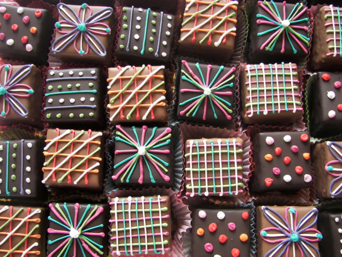 Basic lines and dots of icing or melted chocolate make easy petit fours decorations.