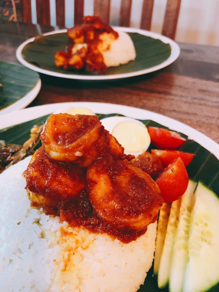 Nasi lemak, or fragrant coconut rice, is known for the aromatic smell of fresh, green pandan leaves and the light flavor of sweet and creamy coconut milk. Pandan leaves are commonly used for coloring and flavoring in Southeast Asian cuisine.