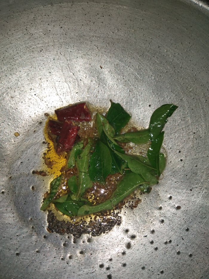 Heat oil in a pan, add mustard seeds, cumin seeds, let them crackle. Add dry red chilies, curry leaves and hing. Saute.