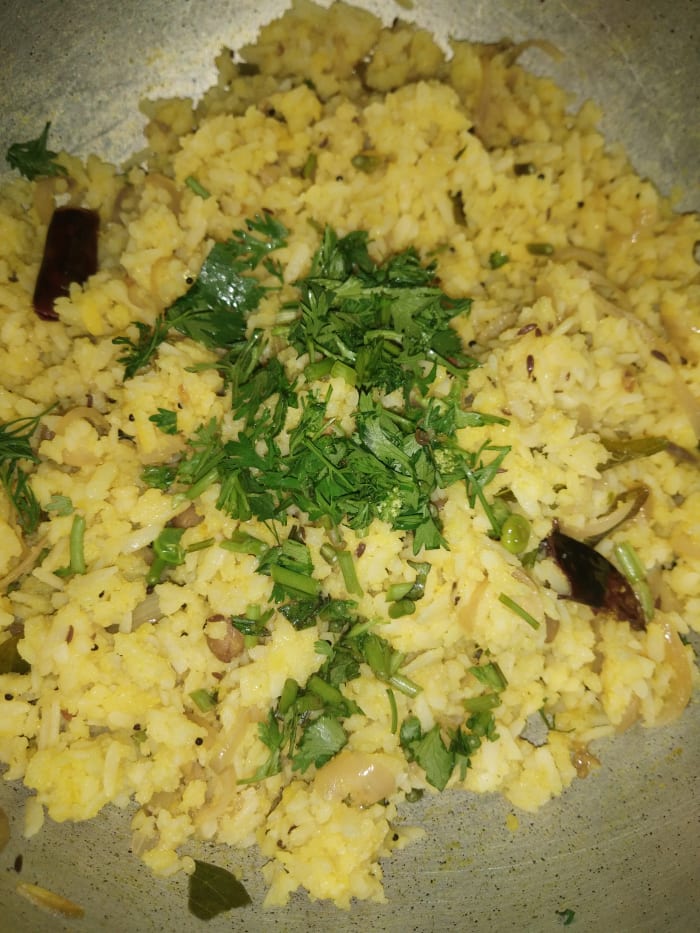 Mix everything properly. Cover and let sit on flame for 1-2 minutes. Garnish with finely chopped fresh coriander leaves. Squeeze lemon and mix well. Serve hot.