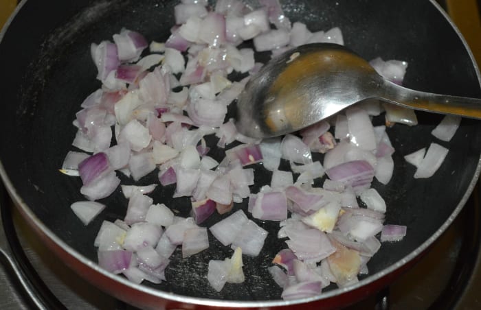 Step 3: Heat the remaining oil in a deep-bottomed pan. Add chopped onions. Saute until they turn pinkish.
