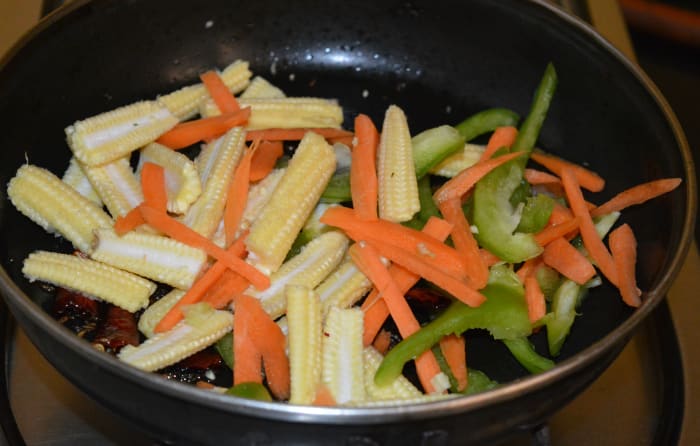 Step two: Throw in all the veggies, except tomatoes and spinach. Add some salt. Saute for 2-3 minutes over medium-high flame.