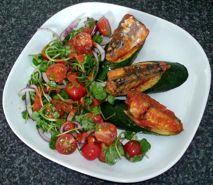 Sardines in tomato sauce are served on pan fried zucchini (courgette) wedges with accompanying salad