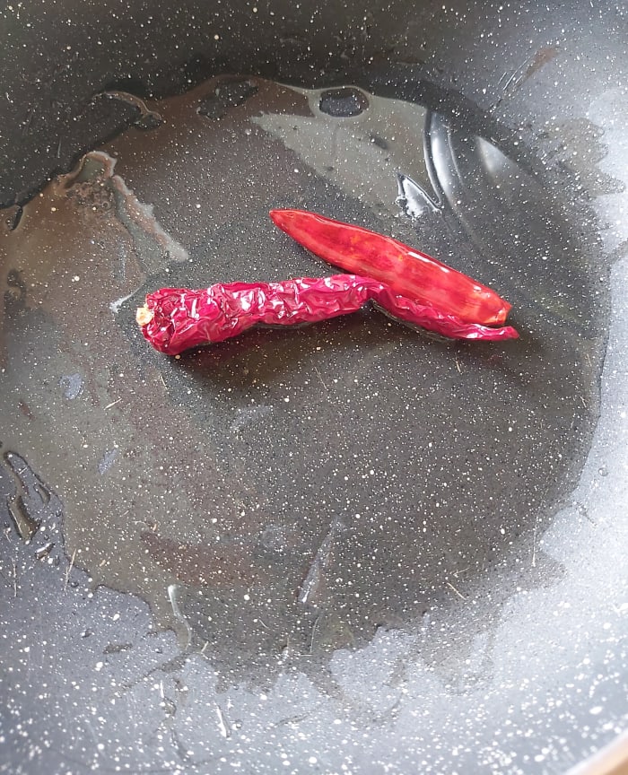 Add red chilies. I used guntur (spicy type) and byadagi (to give color). You can increase the quantity of chilies to make it more spicy. Fry over low flame till they become crisp.