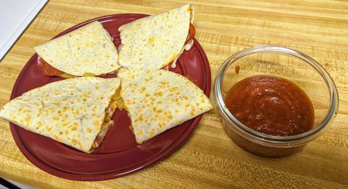 Pizzadillas can be cut into halves or quarters, and are best served with a side of sauce.