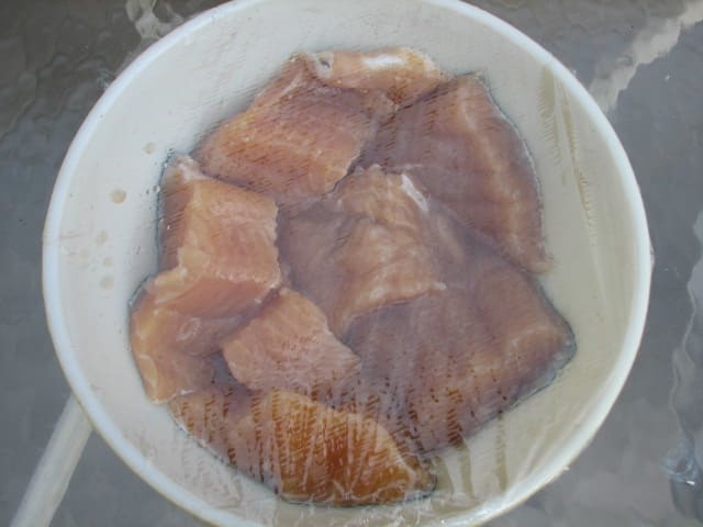 The fish soaked all night in this covered dish . The marinade has been drained to put the liquid in the drip pan of the smoker.