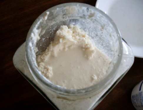 Butter has formed. This shows the separation of butter and buttermilk. The butter here looks somewhat lumpy, because it's been whipped around, but you'll want to compare the texture of your finished product to the cream with which you started.