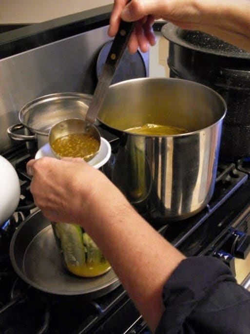 Ladle hot solution over cucumbers, leaving a 1/2-inch headspace. Wipe rim of jar with clean, damp cloth or paper towel.