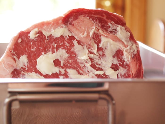 Using a metal roasting pan (the inexpensive aluminum ones work fine), place the roast rib side down (fat side up) into the roasting pan.