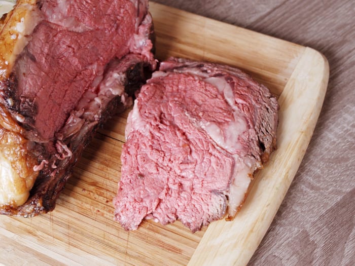 When you are ready to slice, carefully cut the roast away from the rack of bones. Then, measure the length of the roast and divide those inches by the number of people eating and slice the roast into evenly thick slices.