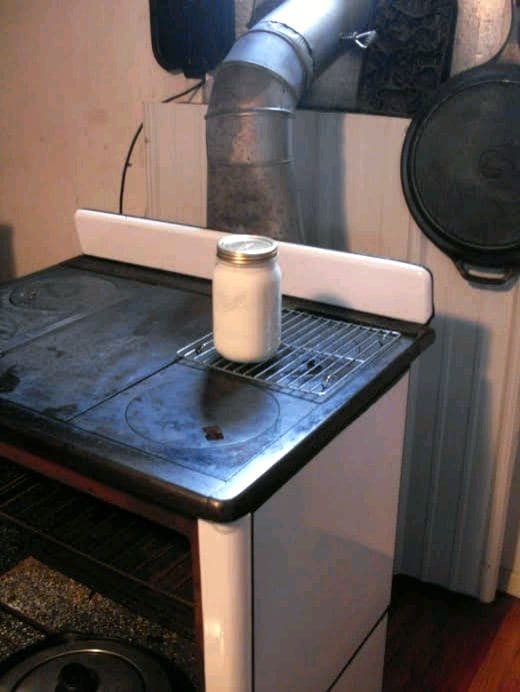 It is usually easy to keep a jar or two of yogurt at the right temperature by setting it on a rack on the "just-warm" side of a wood burning stove.