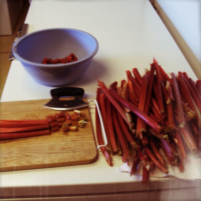 Rhubarb is largely water and may usually be chopped coursely, as it cooks down a lot. 1/2" pieces are good for pies, 1/4" for cakes or breads. Split thick stalks lengthwise, then lay 3 or 4 together, and chop. Peel only as necessary.