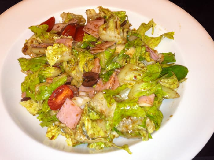 The big arsed salad with romaine, grape tomatoes, kalamata olives, and dressing made with balsamic vinegar.