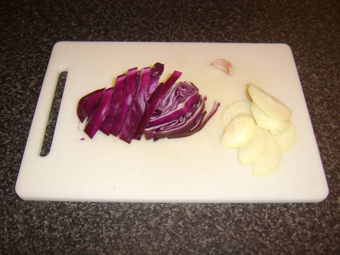 Use the recipe for red cabbage and pear, but substitute 1 small, sliced white onion and 1 large, sliced clove of garlic, as shown here.