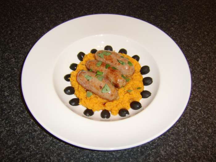A ring of black olive halves make an attractive final garnish for this Mediterranean style bangers and mash