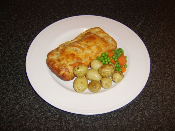 A fillet of fresh whiting is cooked in a puff pastry parcel and served with fresh assorted vegetables
