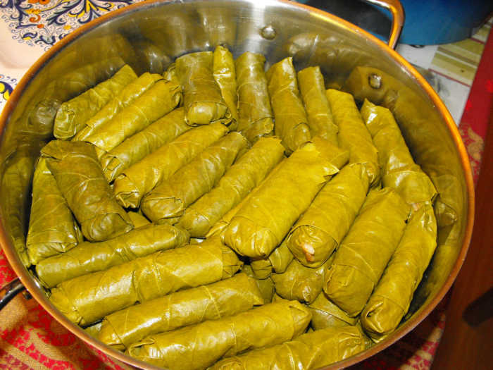This photo shows the stacked yalanchi sarma ready to be covered with the extra grape leaves and cooked.