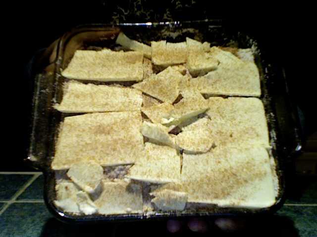 I did my best to evenly cover the mixture with my butter slices. Optional: Add a very light layer of cinnamon and sugar over the butter slices before baking.
