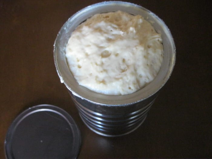 The dough has risen & the lid has popped off the coffee can. This coffee can is now ready to go into the oven.
