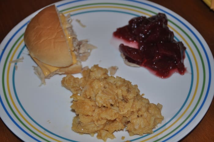 With tasty side dishes, you can offer your guests a complete meal they will rave about. Pictured with the cheesy potatoes is a turkey gravy sandwich with cheese and cranberries.