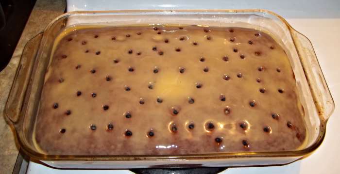 Poke holes into the cake using the end of a wooden spoon or a fork, depending on how large you want the holes to be.
