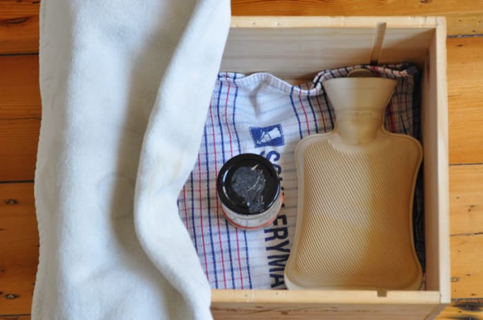 My make-shift proofing box. I put the starter or leaven in with a hot water bottle and cover with a thick oven cloth. Image: © Siu Ling Hui