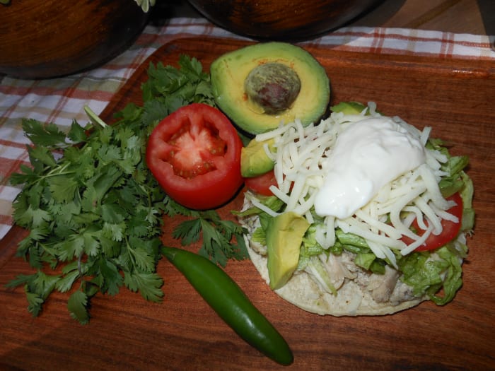 The options for creating your own chalupa are endless. Here is one with shredded boiled chicken, shredded lettuce, shredded mozzarella, sliced tomato, sliced avocado and Mexican crema. Delicioso!