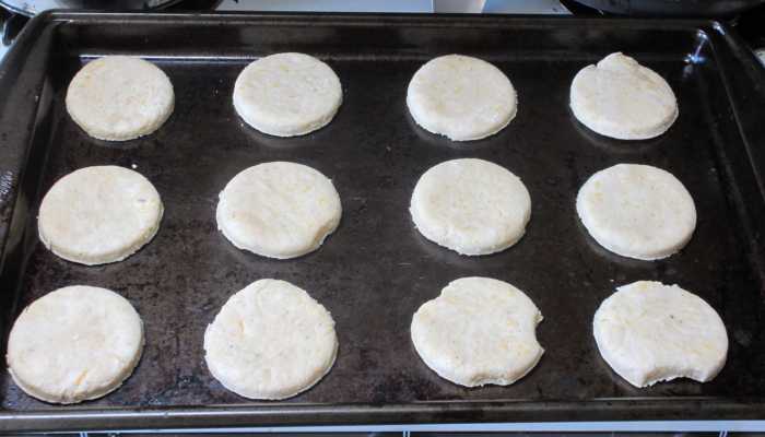 Punch out circles of dough and place them on a greased or nonstick cookie sheet. Mine is old and battered, but it works great!
