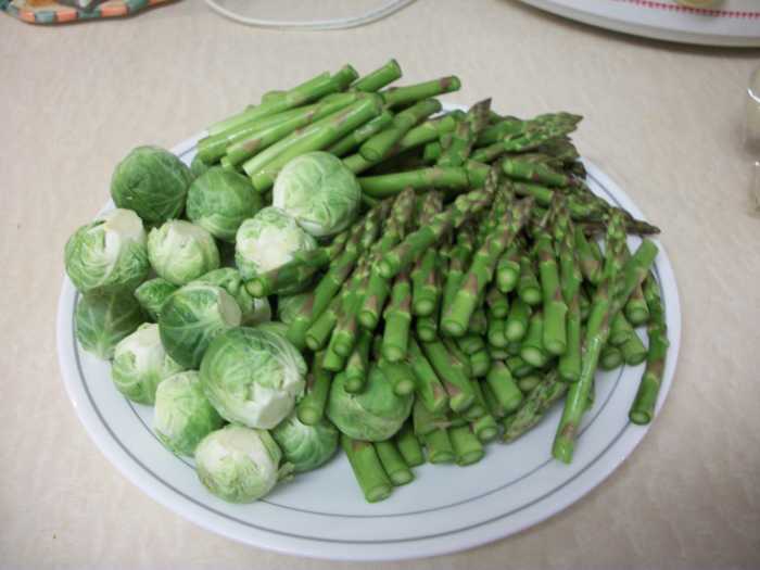 Step 1. Cut the stems off of the Brussels sprouts and remove the outer leaves (these cause bitterness). Then cut the asparagus into 3-4 inch pieces and discard the woody stems (at the very bottom of the stem).