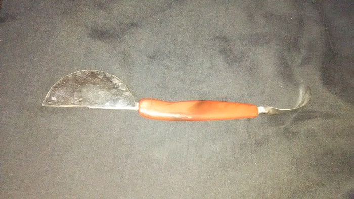 The two ends must work together on the same food target. The pointed end must peel or remove something but the other have two half moons about 1/4" apart. The 'handle' is plastic or bakelite.