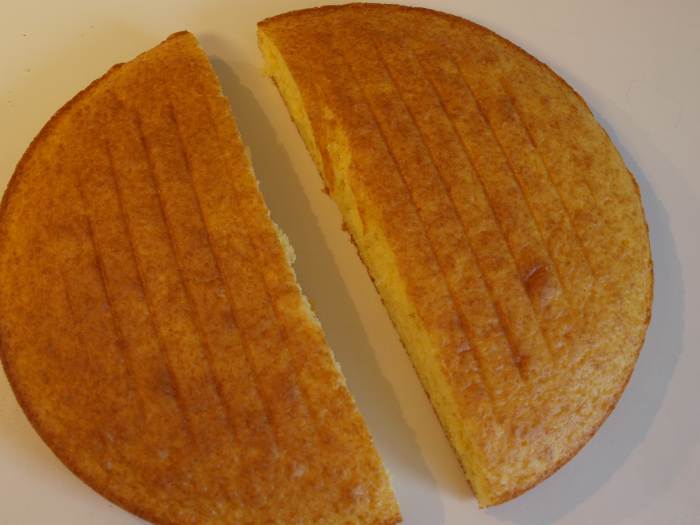 Cut the round cake evenly in half using a sharp knife. Only cut after cake is completely cooled.