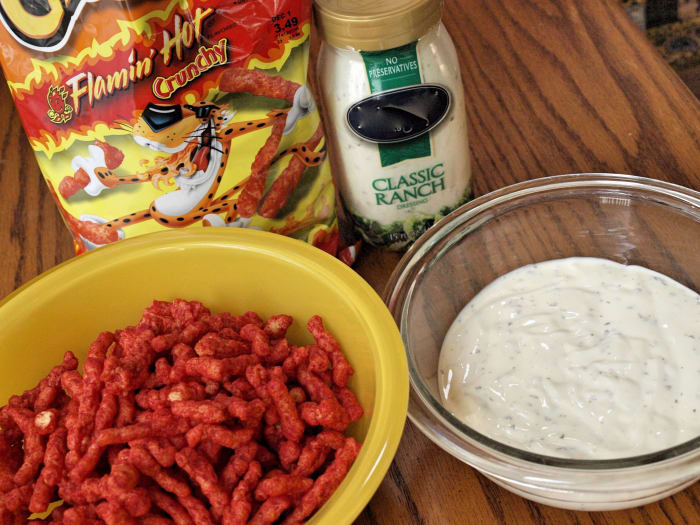 Flamin' Hot Cheetos and ranch dressing. This is all you need to coat your chicken with before popping it into the oven!