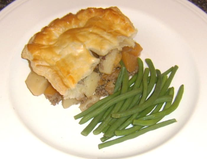 Mince, tattie and neeps are incorporated in a puff pastry pie and served simply with green string beans