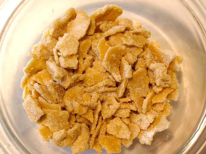 Tear up the second frozen shell and toss it in sugar. Now your topping is ready for the pie.