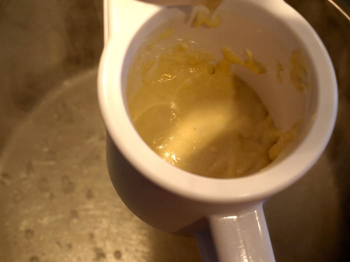 Cook the noodles: Place some of the batter in your spaetzle-maker and add it to the boiling water.