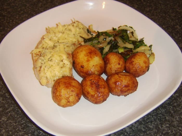 Sweetheart cabbage is sauteed with onion and soy sauce before being served with cheesy turkey fillet and pan roasted potatoes.