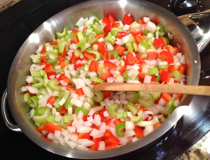 Cook chopped vegetables and minced garlic in oil over medium-low heat until tender, about 20 minutes.