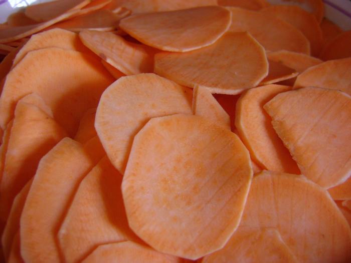 Once the oil is hot and ready to go, I start cooking the sweet potato slices, while they cook, I continue to peel and slice to save time.