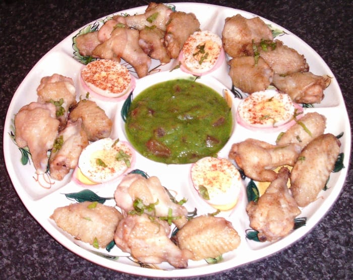 Roast chicken wings spiced with paprika are served with hard boiled eggs and zucchini based guacamole.