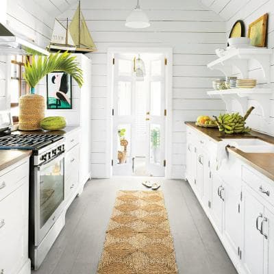 Leaving the set of doors as is with no curtains or other coverings brings a lot of light into this narrow kitchen.