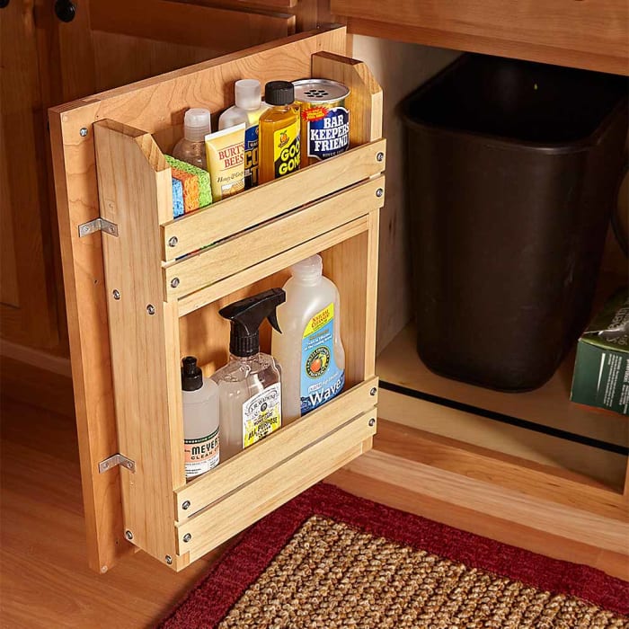 This simple wooden cabinet door storage rack frees up valuable under the sink storage while offering easy access to frequently used cleaning supplies.