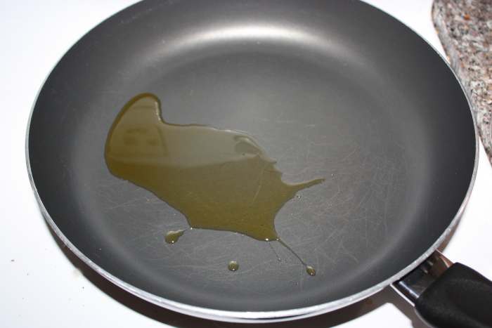 Heat oil in a large saucepan over medium-high heat. Add rice and cook, stirring occasionally, until golden brown.
